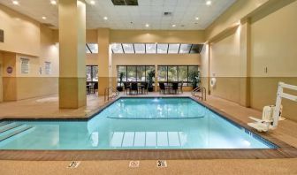 Relaxing indoor pool with seating area at Embassy Suites By Hilton Santa Clara Silicon Valley.