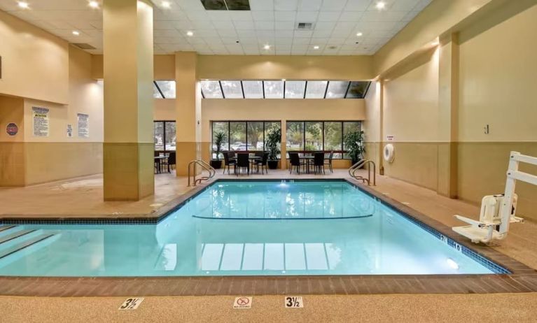 Relaxing indoor pool with seating area at Embassy Suites By Hilton Santa Clara Silicon Valley.