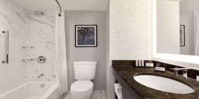 Private guest bathroom with shower and bath at Embassy Suites By Hilton Santa Clara Silicon Valley.