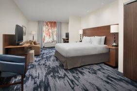 King bedroom with TV and work space at Fairfield Inn & Suites by Marriott Baltimore BWI Airport.