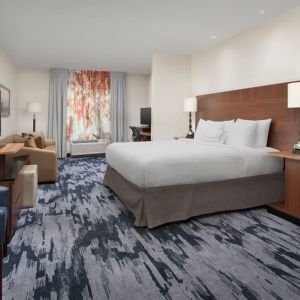 King bedroom with TV and work space at Fairfield Inn & Suites by Marriott Baltimore BWI Airport.