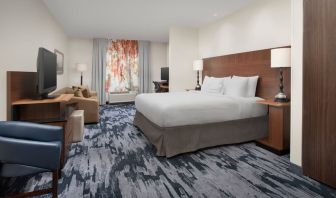 King bedroom with TV and work space at Fairfield Inn & Suites by Marriott Baltimore BWI Airport.