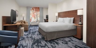 King bedroom with TV and work space at Fairfield Inn & Suites by Marriott Baltimore BWI Airport.