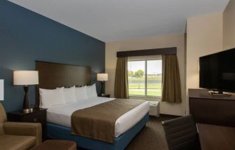 Day use room with work desk and sofa at AmericInn By Wyndham Sioux Falls North.