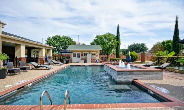 Stunning outdoor pool at Homewood Suites By Hilton Dallas-Lewisville.