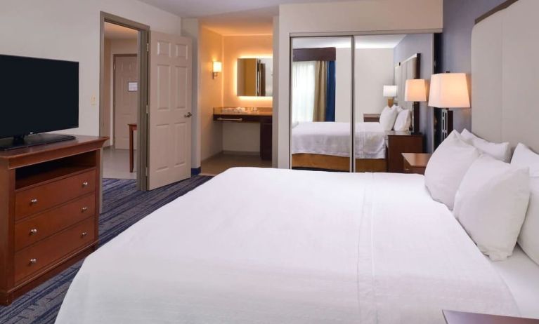 Delux king bed with TV at Homewood Suites By Hilton Dallas-Lewisville.