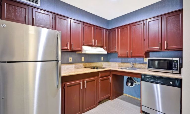 Day room equipped with kitchen, refrigerator, and microwave at Homewood Suites By Hilton Dallas-Lewisville.