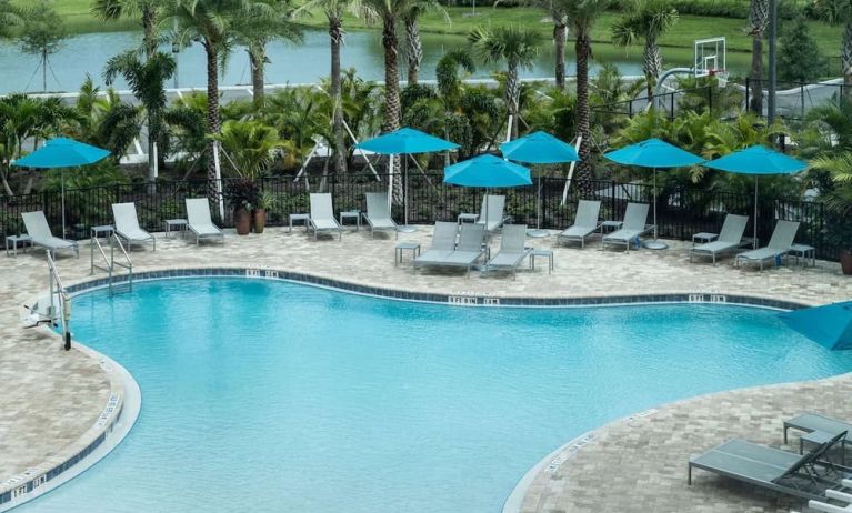 Relaxing pool area with pool chairs at Hampton Inn & Suites Cape Canaveral Cruise Port.