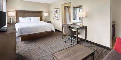 Day use room with work desk and sofa at Hampton Inn & Suites Alexandria.
