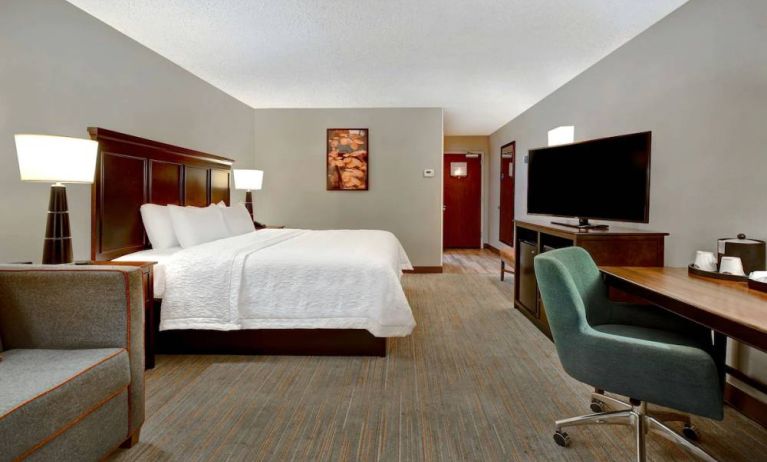 Day use room with work desk and sofa at Hampton Inn & Suites Alexandria.