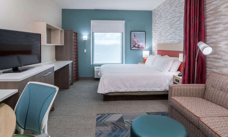 Delux king room with natural light at Home2 Suites By Hilton Cape Canaveral Cruise Port.