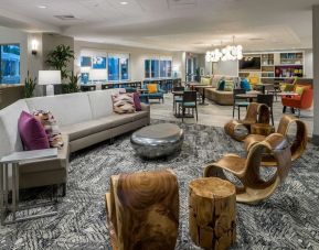 Lobby and coworking space at Home2 Suites By Hilton Cape Canaveral Cruise Port.