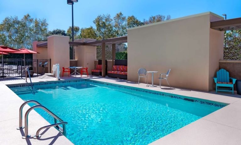 Stunning outdoor pool with seating area at Home2 Suites By Hilton Charleston Airport/Convention Center.