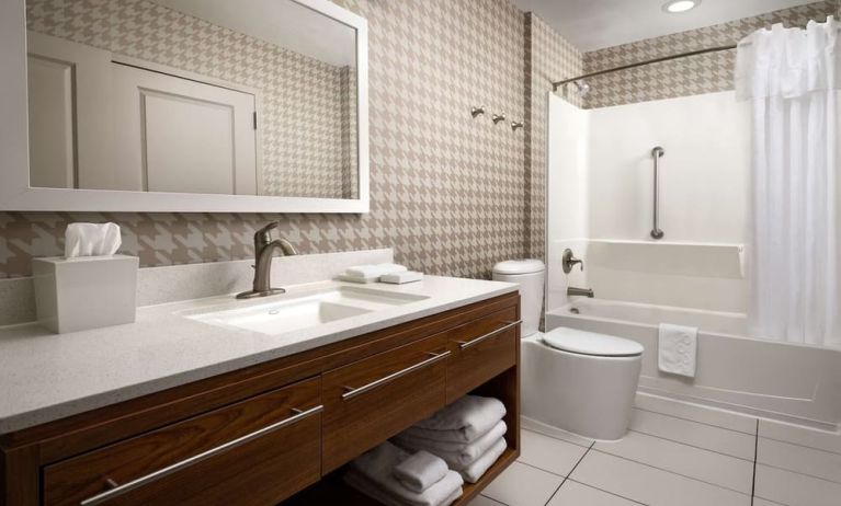 Guest bathroom with shower and bath at Home2 Suites By Hilton Charleston Airport/Convention Center.