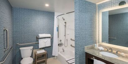 Guest bathroom with shower and tub at Homewood Suites By Hilton Miami Airport-Blue Lagoon.