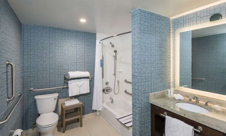 Guest bathroom with shower and tub at Homewood Suites By Hilton Miami Airport-Blue Lagoon.