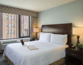 Delux king bed with natural light at Hilton Garden Inn New York/Tribeca.