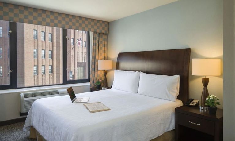 Delux king bed with natural light at Hilton Garden Inn New York/Tribeca.