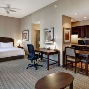 Spacious king bed with business desk at Homewood Suites By Hilton Burlington.