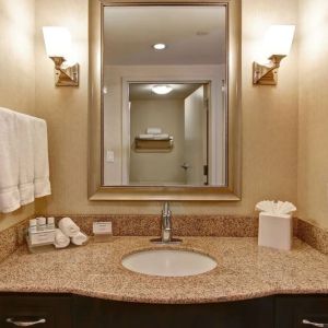 Guest bathroom with shower at Homewood Suites By Hilton Burlington.