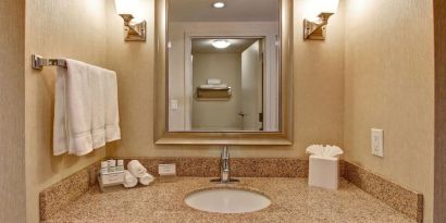 Guest bathroom with shower at Homewood Suites By Hilton Burlington.