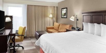 Day use room with work desk and sofa at Hampton Inn Dallas-Irving-Las Colinas.