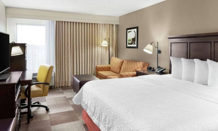 Day use room with work desk and sofa at Hampton Inn Dallas-Irving-Las Colinas.