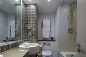 Guest bathroom with shower and bath at DoubleTree By Hilton Stratford-upon-Avon.