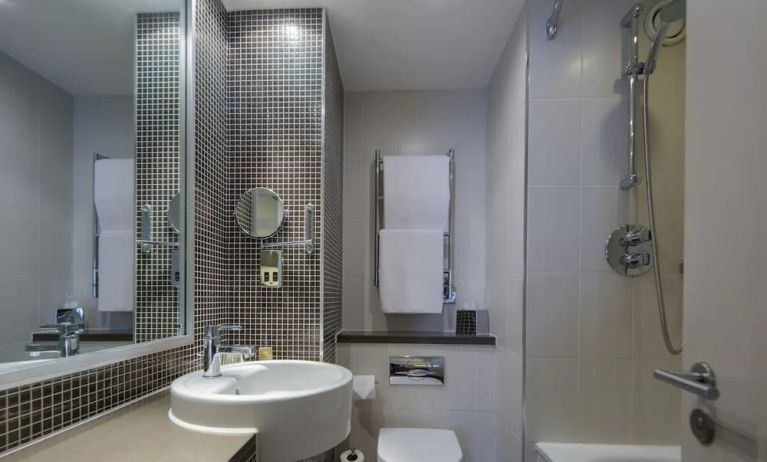 Guest bathroom with shower and bath at DoubleTree By Hilton Stratford-upon-Avon.