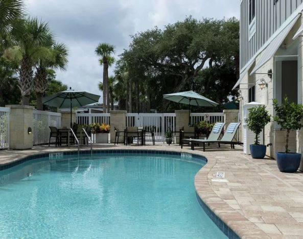 Lovely outdoor pool with pool chairs at Hampton Inn New Smyrna Beach.