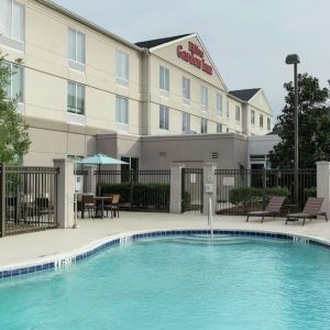 Stunning outdoor pool with pool chairs at Hilton Garden Inn Dothan.