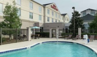 Stunning outdoor pool with pool chairs at Hilton Garden Inn Dothan.