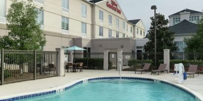 Stunning outdoor pool with pool chairs at Hilton Garden Inn Dothan.