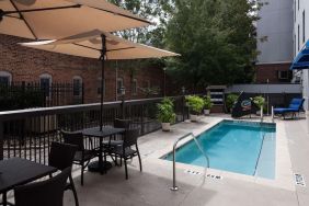 Outdoor pool with seating area at Hampton Inn & Suites Gainesville-Downtown.