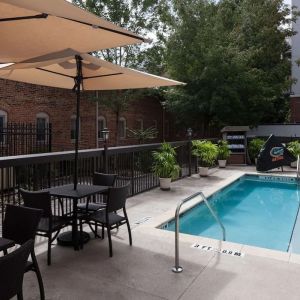 Outdoor pool with seating area at Hampton Inn & Suites Gainesville-Downtown.