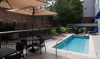 Outdoor pool with seating area at Hampton Inn & Suites Gainesville-Downtown.