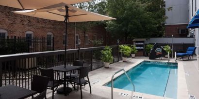 Outdoor pool with seating area at Hampton Inn & Suites Gainesville-Downtown.