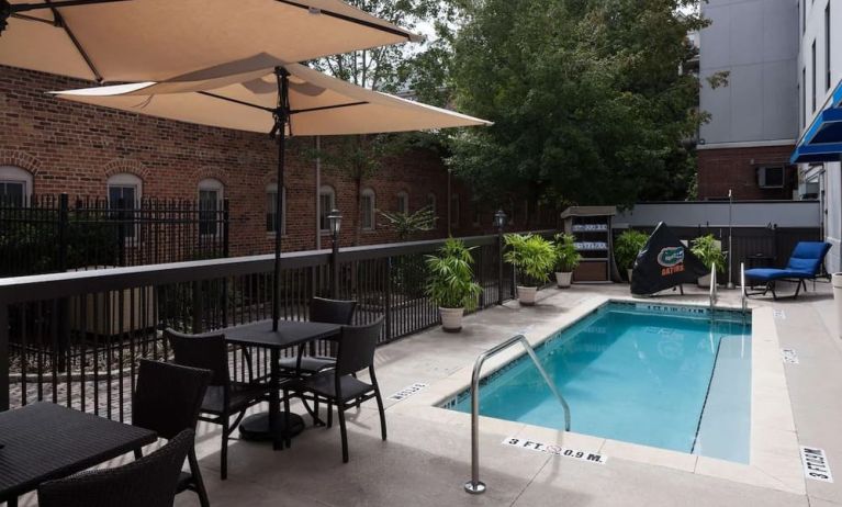 Outdoor pool with seating area at Hampton Inn & Suites Gainesville-Downtown.