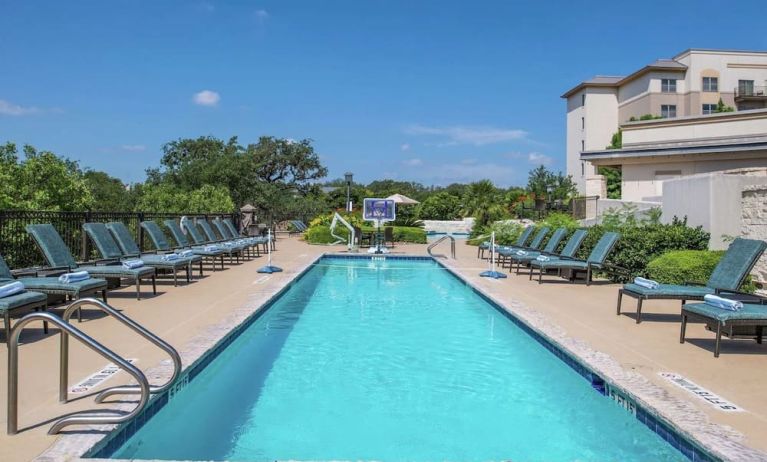 Stunning outdoor pool with pool chairs at Hilton San Antonio Hill Country.