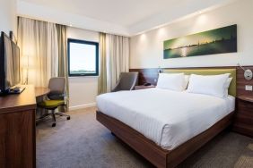 King bed with natural light at Hampton By Hilton Humberside Airport.