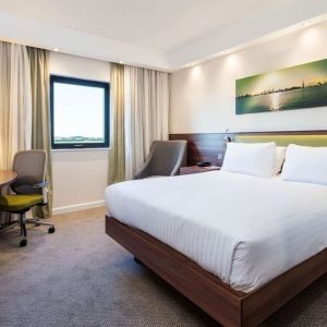 King bed with natural light at Hampton By Hilton Humberside Airport.