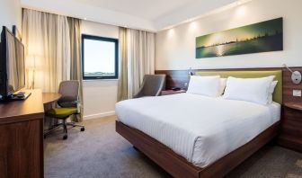 King bed with natural light at Hampton By Hilton Humberside Airport.