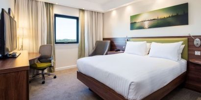 King bed with natural light at Hampton By Hilton Humberside Airport.