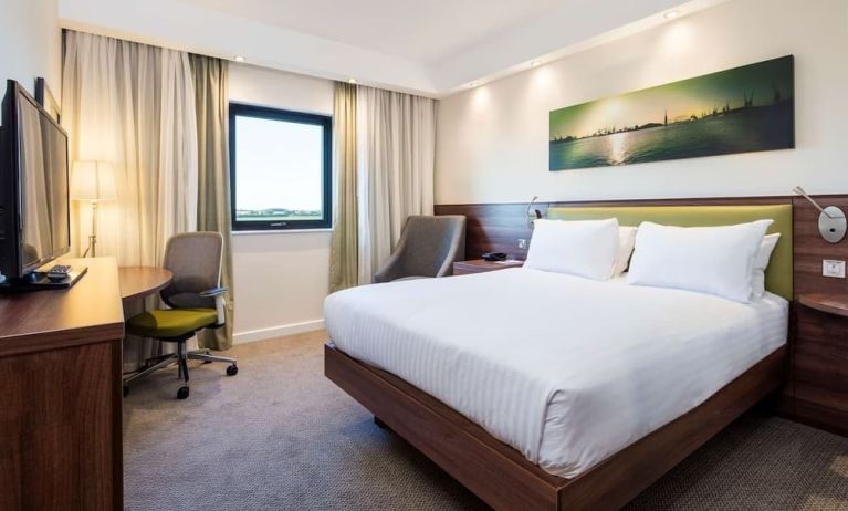 King bed with natural light at Hampton By Hilton Humberside Airport.