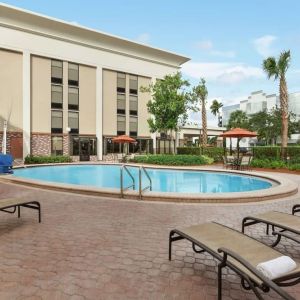 Stunning outdoor pool with pool chairs at Hampton Inn Ft. Lauderdale-Cypress Creek.