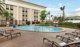 Stunning outdoor pool with pool chairs at Hampton Inn Ft. Lauderdale-Cypress Creek.