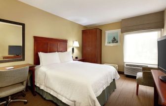 King bed with business desk at Hampton Inn Ft. Lauderdale-Cypress Creek.