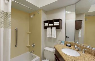 Guest bathroom with shower and bath at Hampton Inn Ft. Lauderdale-Cypress Creek.