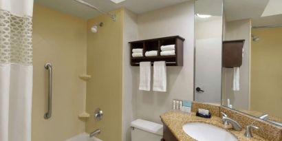 Guest bathroom with shower and bath at Hampton Inn Ft. Lauderdale-Cypress Creek.