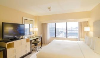 King bed with TV and business desk at Hilton Los Angeles Airport.